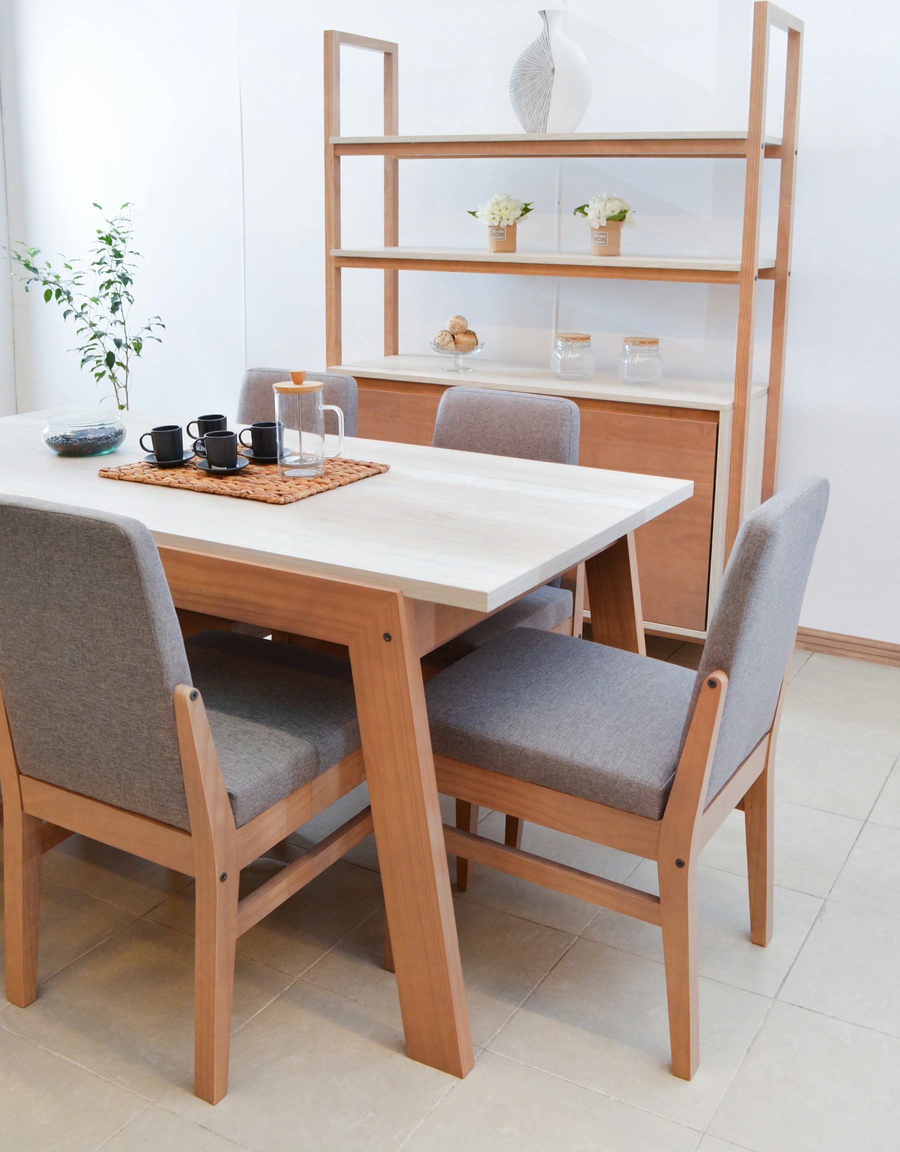 Bright dining area with timber table and soft grey chairs